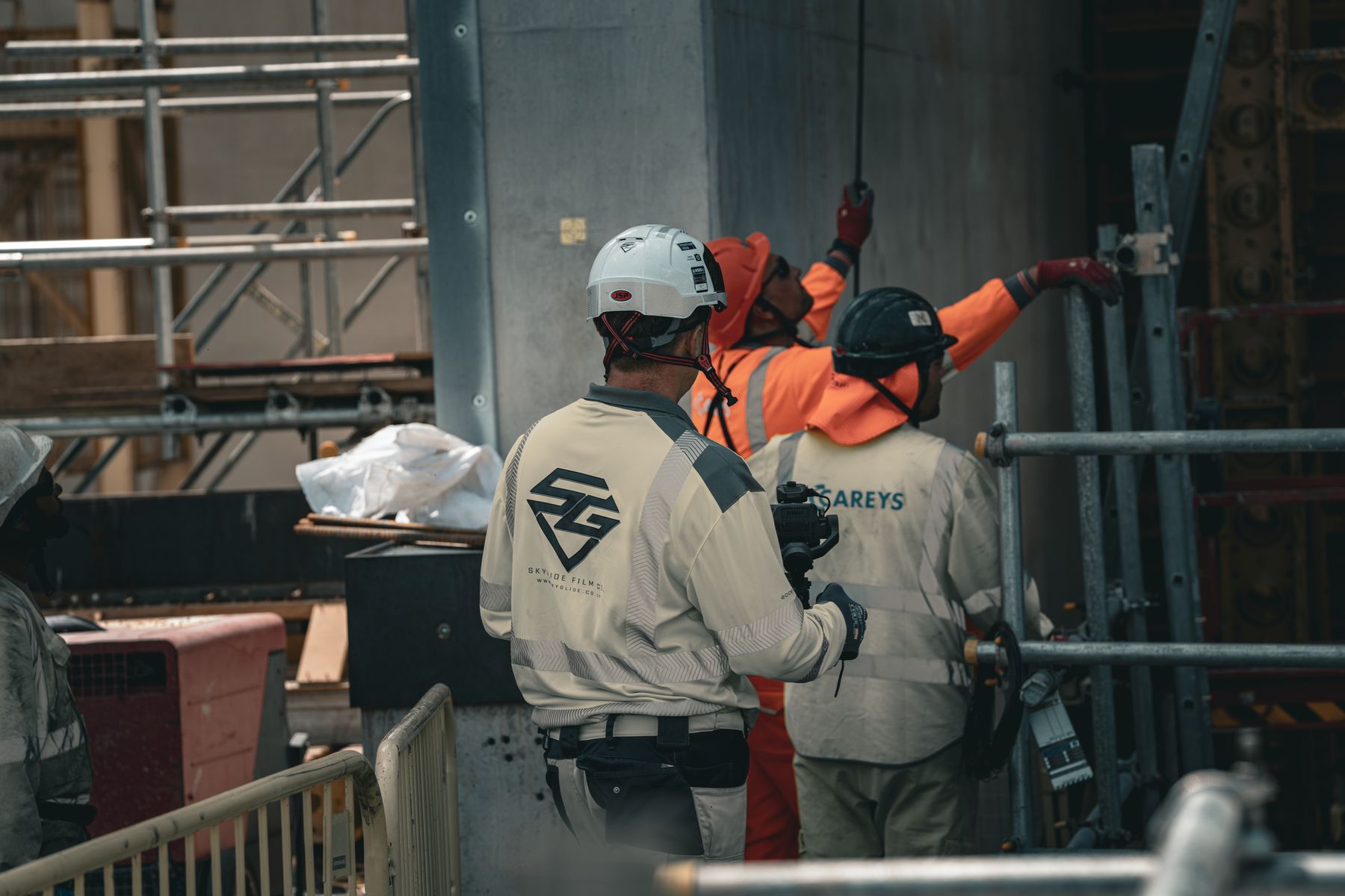 SkyGlide crew rigging camera equipment on an active construction site