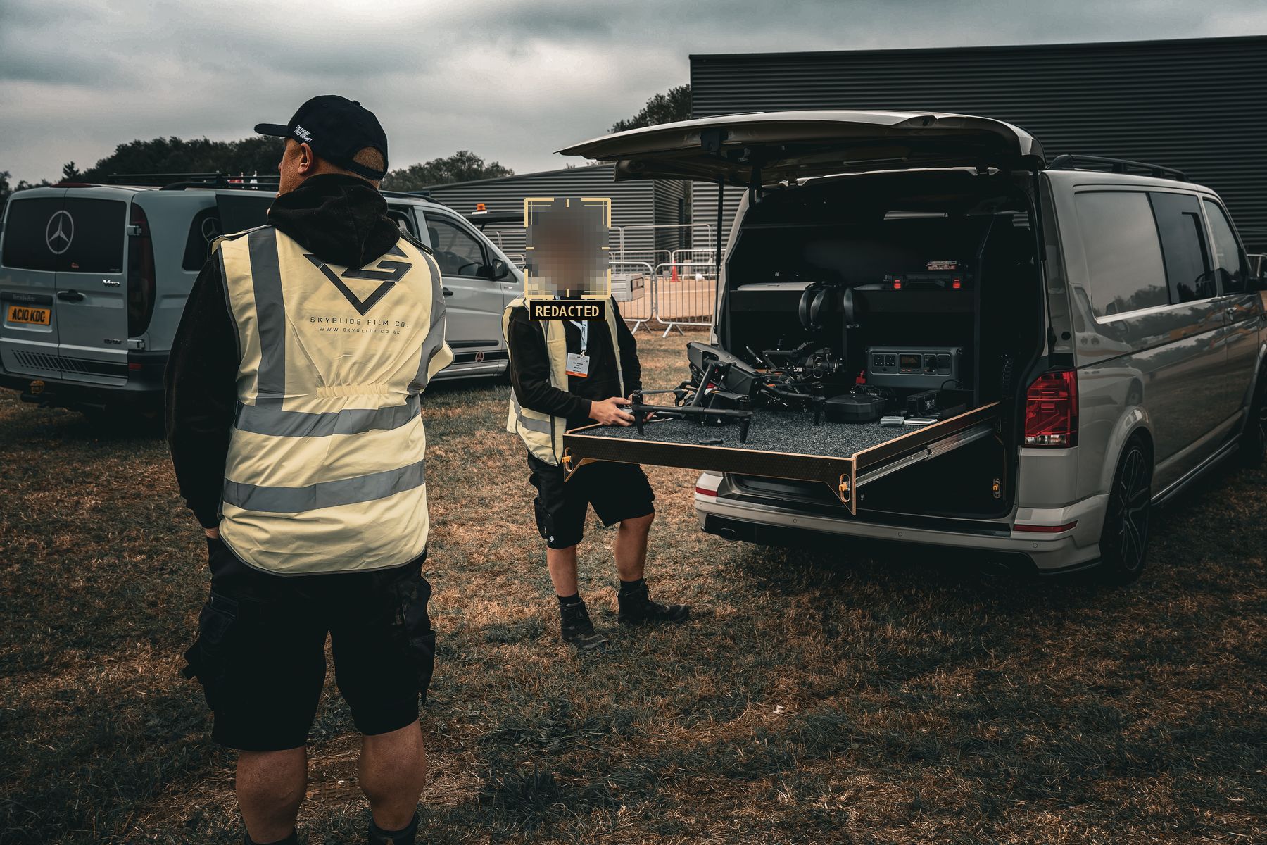 SkyGlide crew preparing drones at their van at DVD, faces redacted