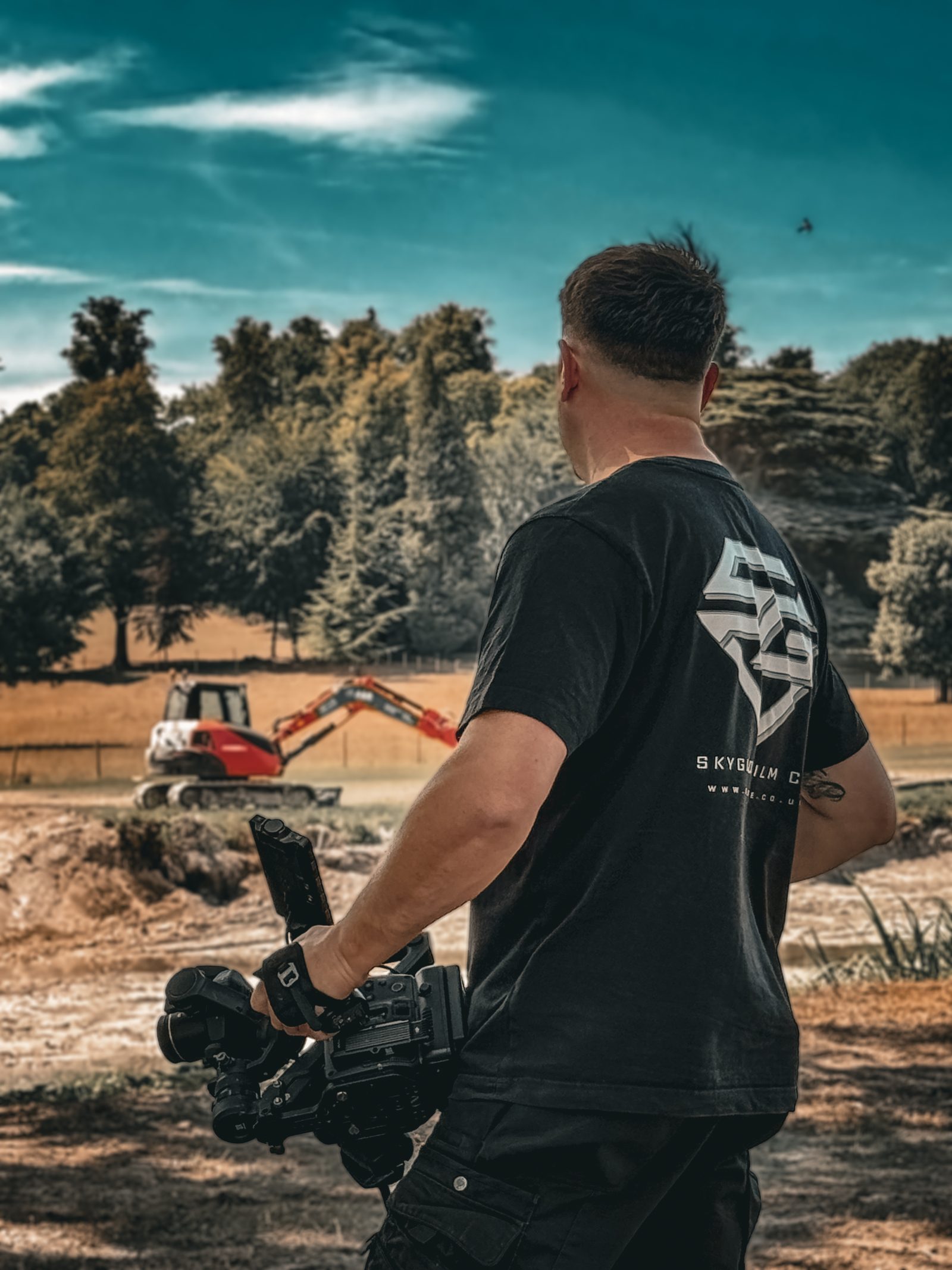 SkyGlide camera operator filming an excavator with a stabilised cinema camera