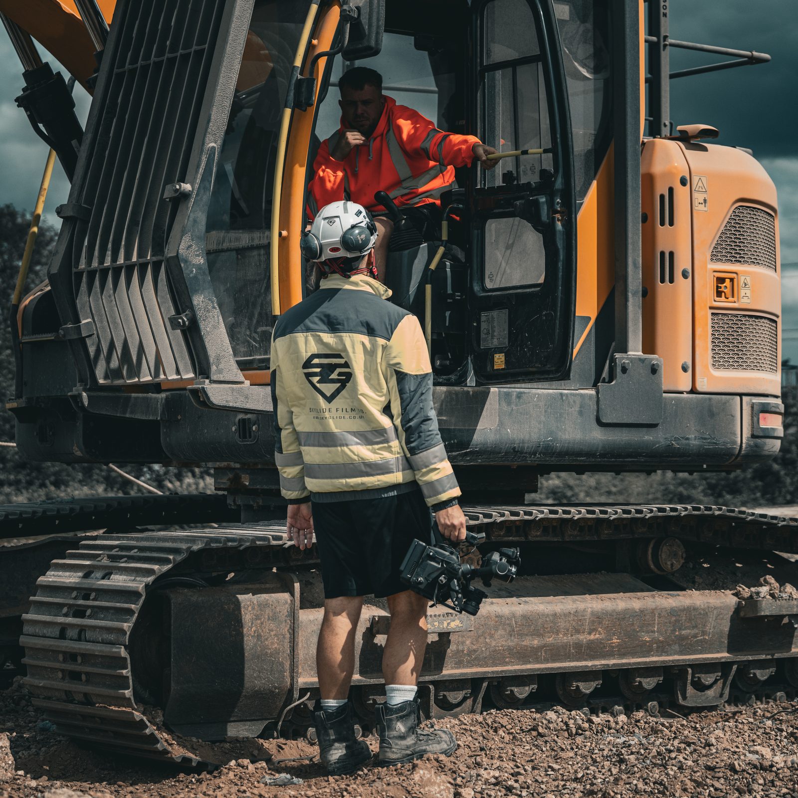 Camera briefing with the excavator operator on a live dig