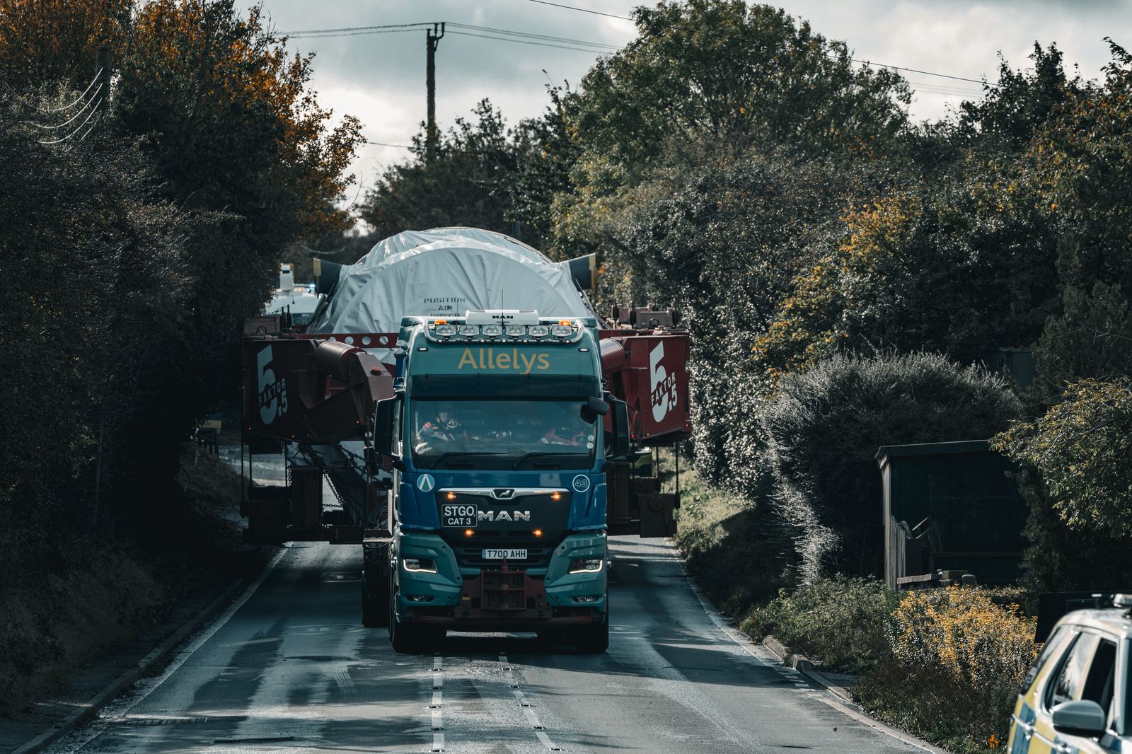Abnormal load under escort on a closed rural road