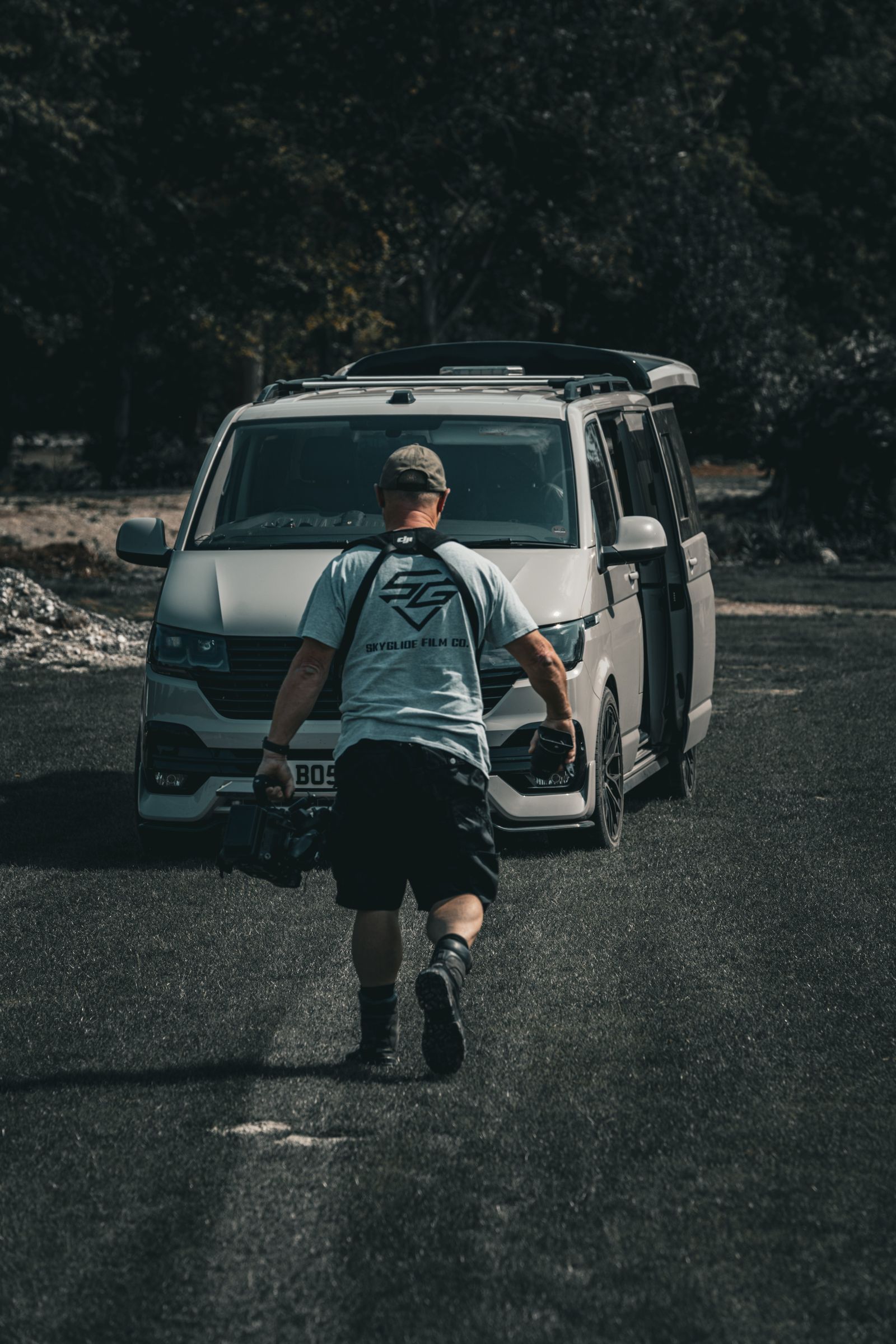 SkyGlide operator carrying a cinema camera back to the crew van